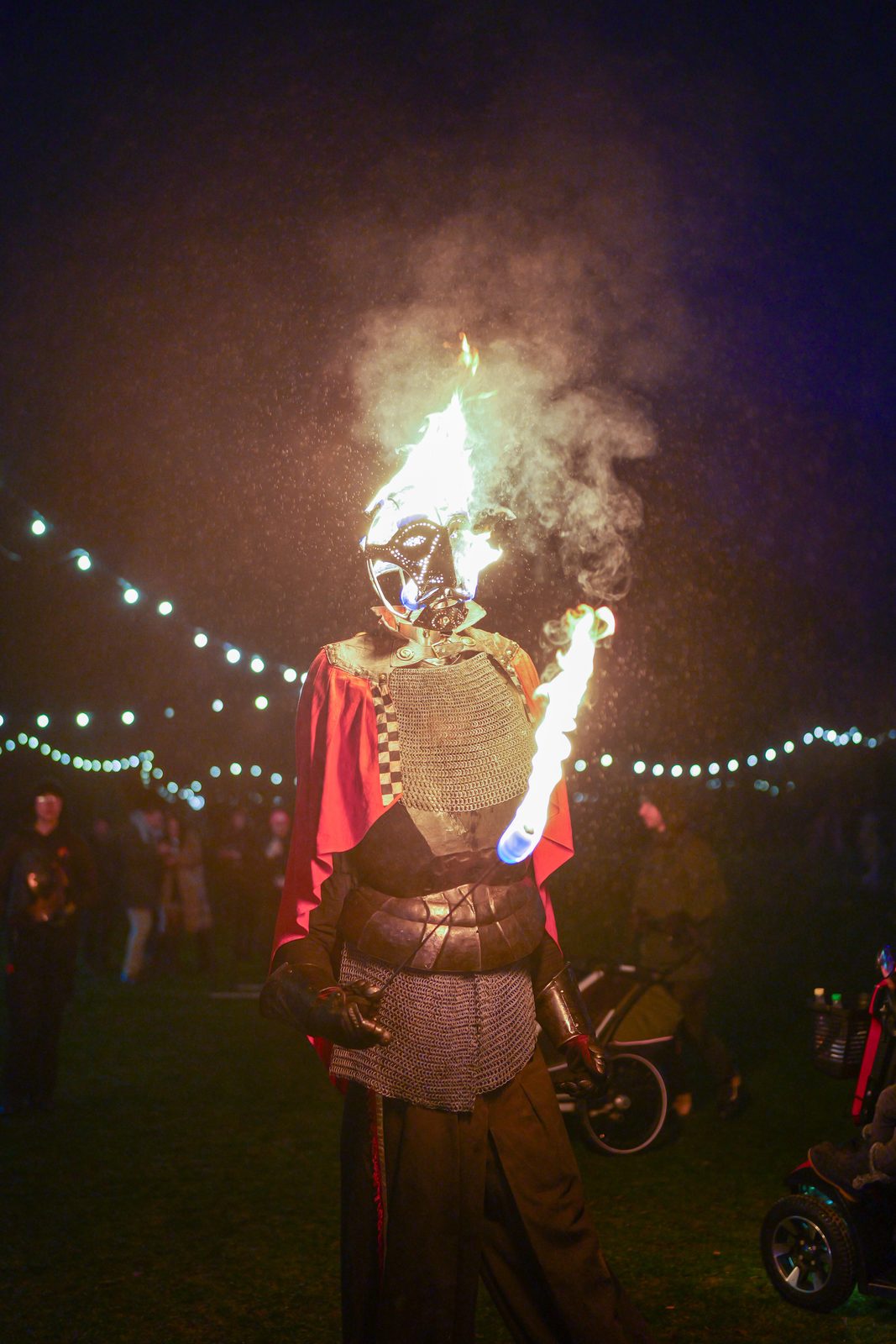 Fire performer in armor at night